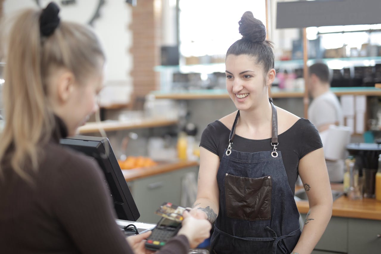 Retail cashier processing a card payment through an integrated POS system